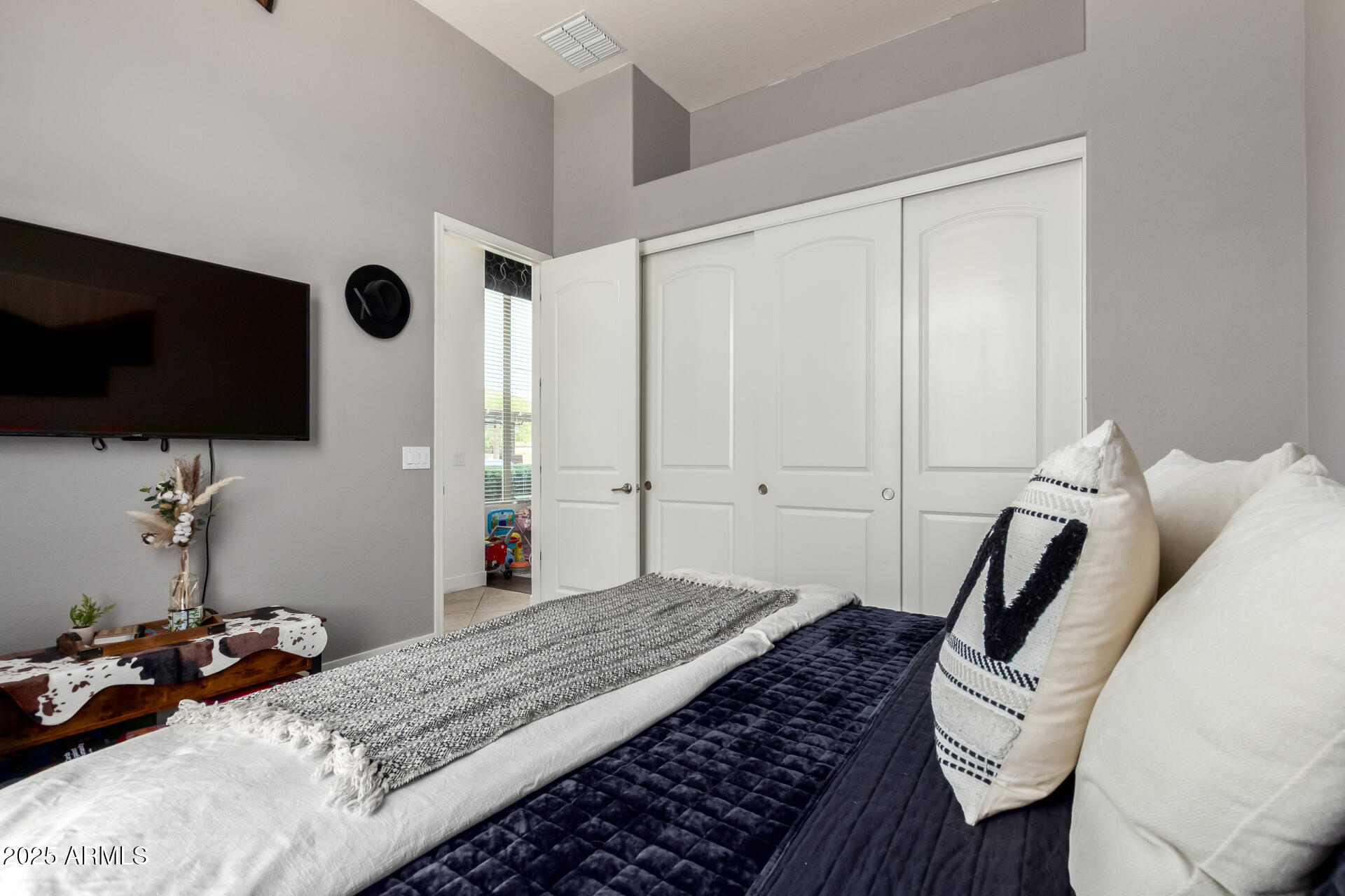 9156 West Bajada Road Peoria, AZ 85383 - Photo 37 of 97 a bedroom with a bed and a flat screen tv