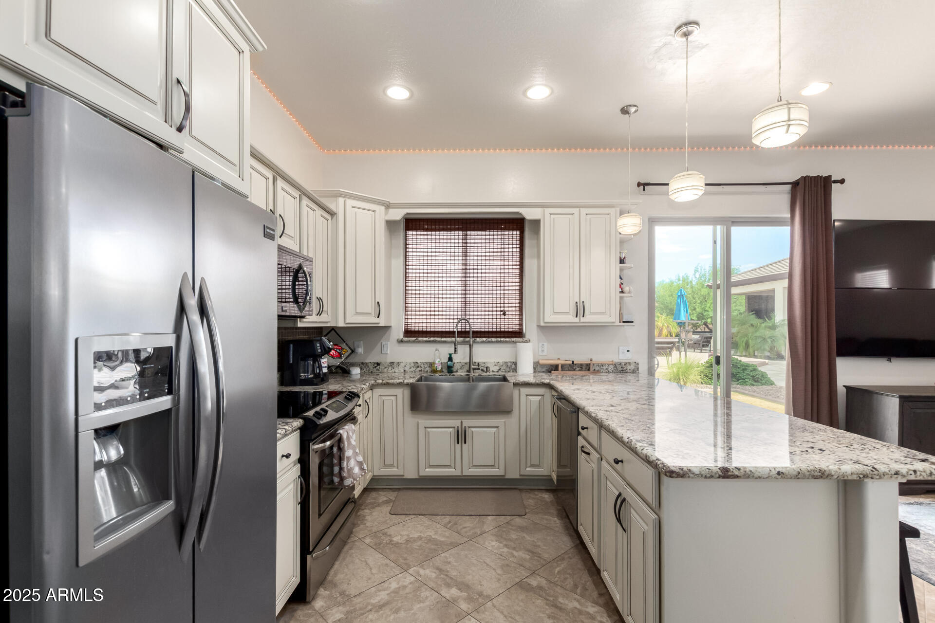 9156 West Bajada Road Peoria, AZ 85383 - Photo 38 of 88 a kitchen with stainless steel appliances granite countertop a sink a stove and a refrigerator