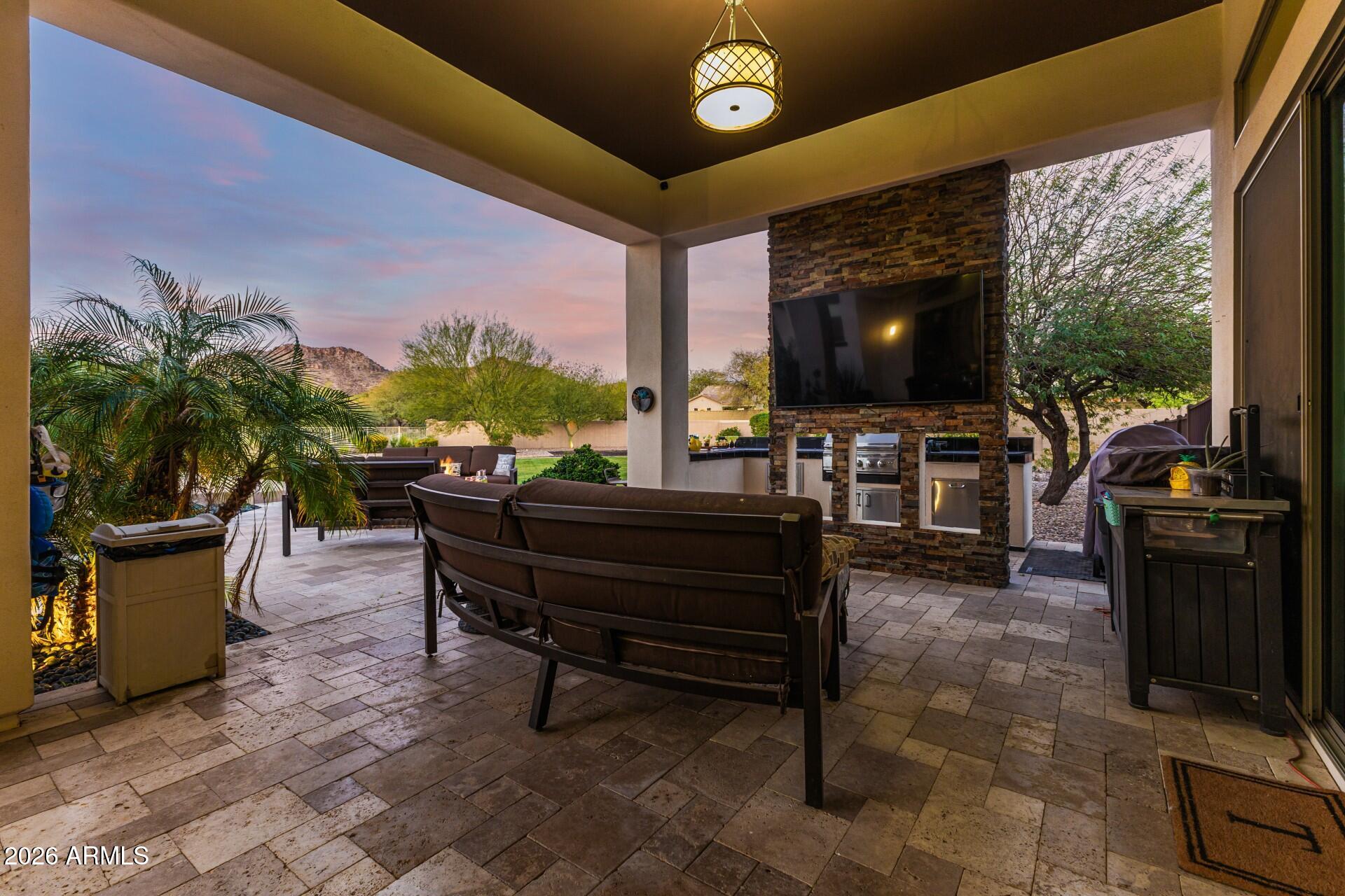 9156 West Bajada Road Peoria, AZ 85383 - Photo 51 of 88 a living room with patio furniture and a flat screen tv