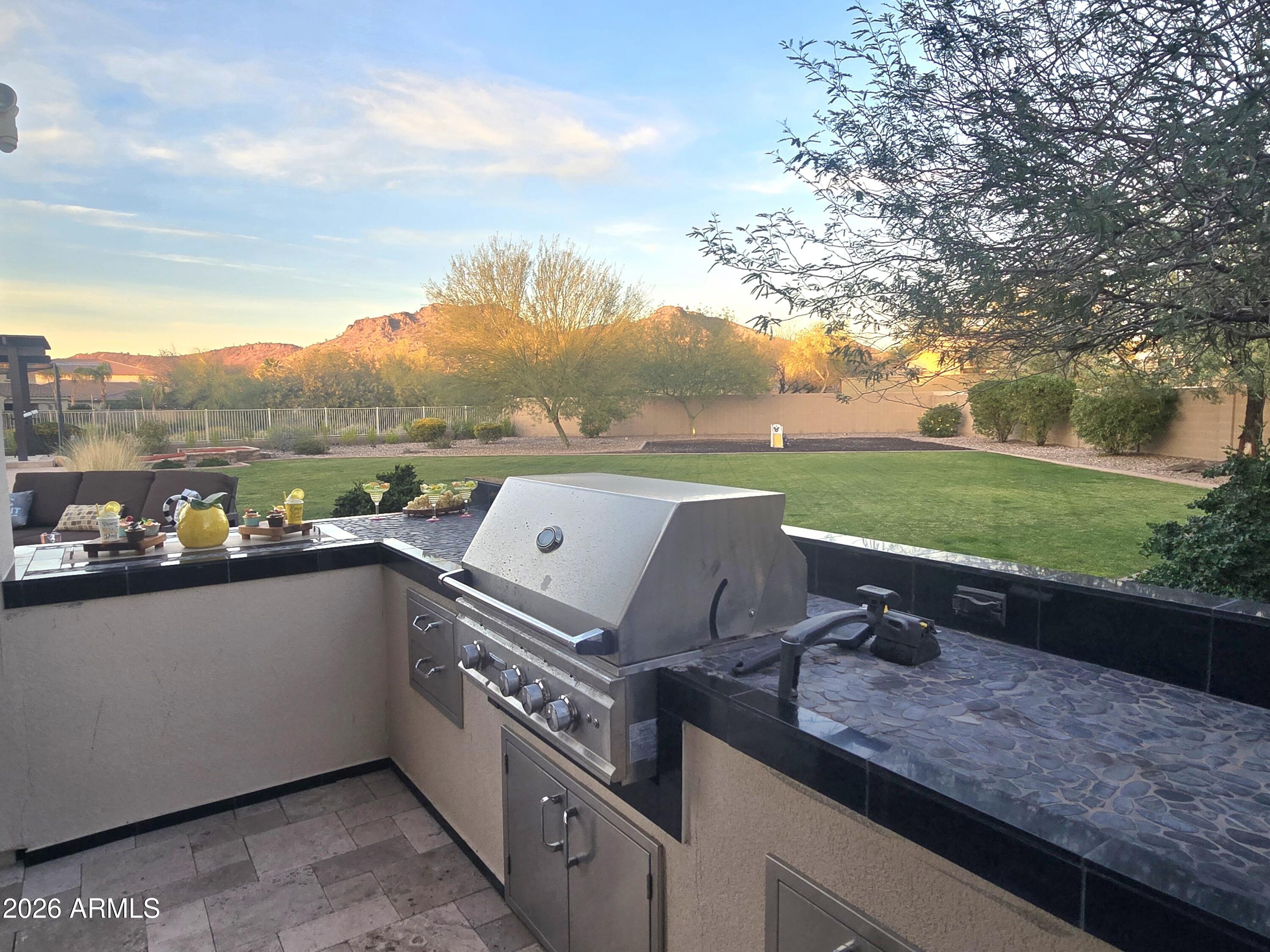 9156 West Bajada Road Peoria, AZ 85383 - Photo 52 of 88 a view of a terrace with a garden and mountain view