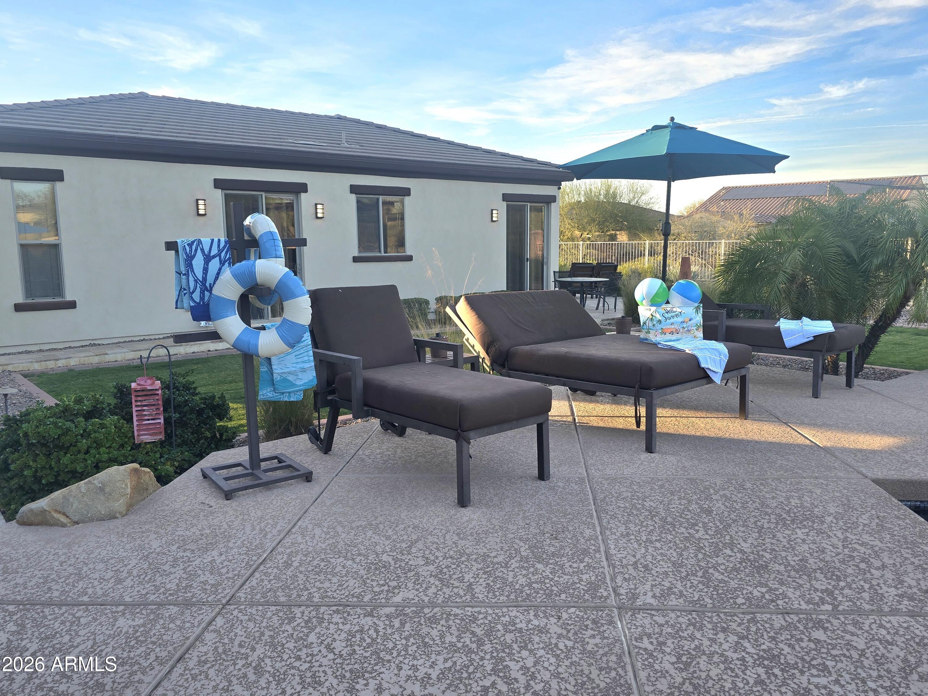 9156 West Bajada Road Peoria, AZ 85383 - Photo 62 of 88 a living room filled with furniture and a garden