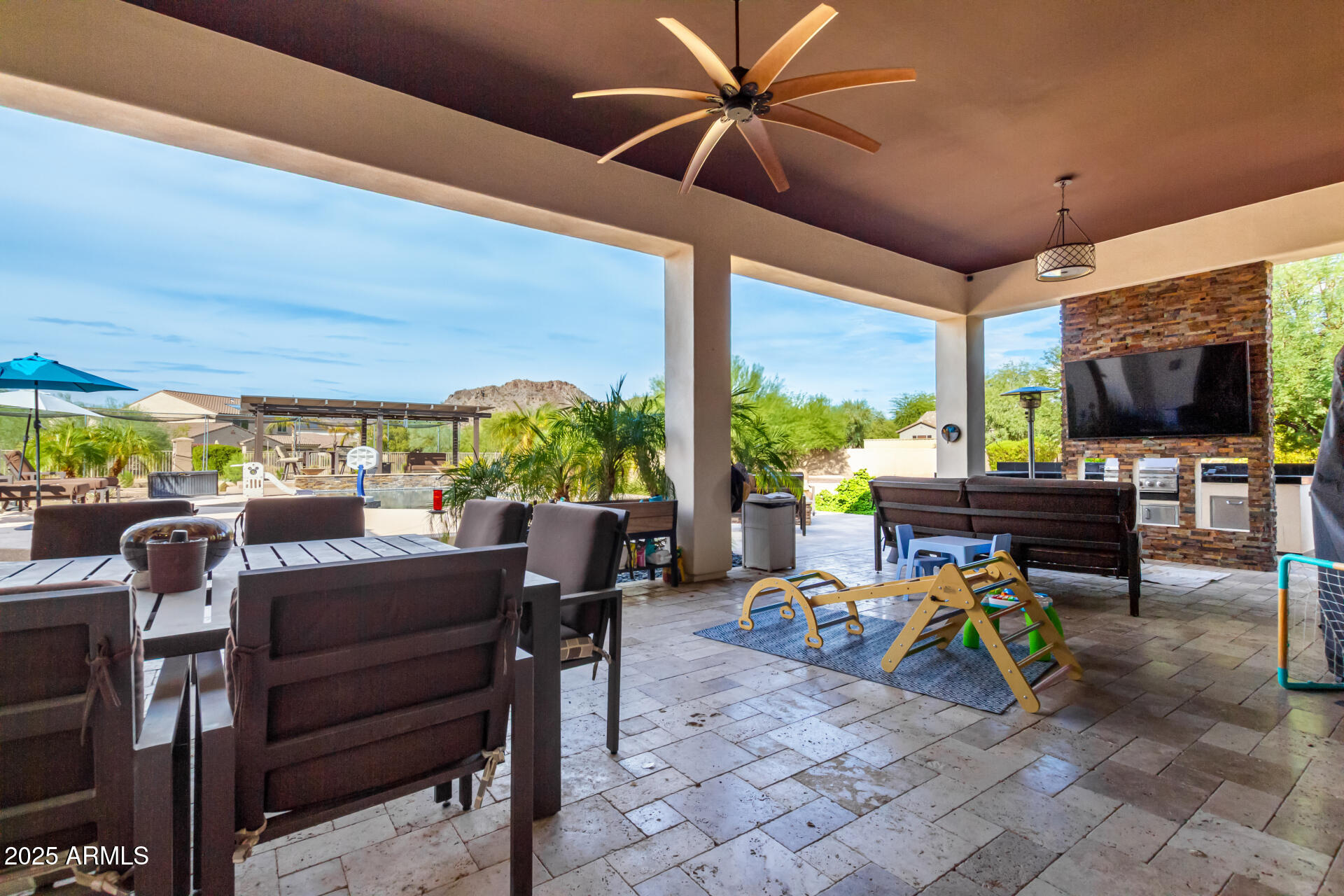 9156 West Bajada Road Peoria, AZ 85383 - Photo 65 of 97 a view of a patio with table and chairs potted plants with wooden floor