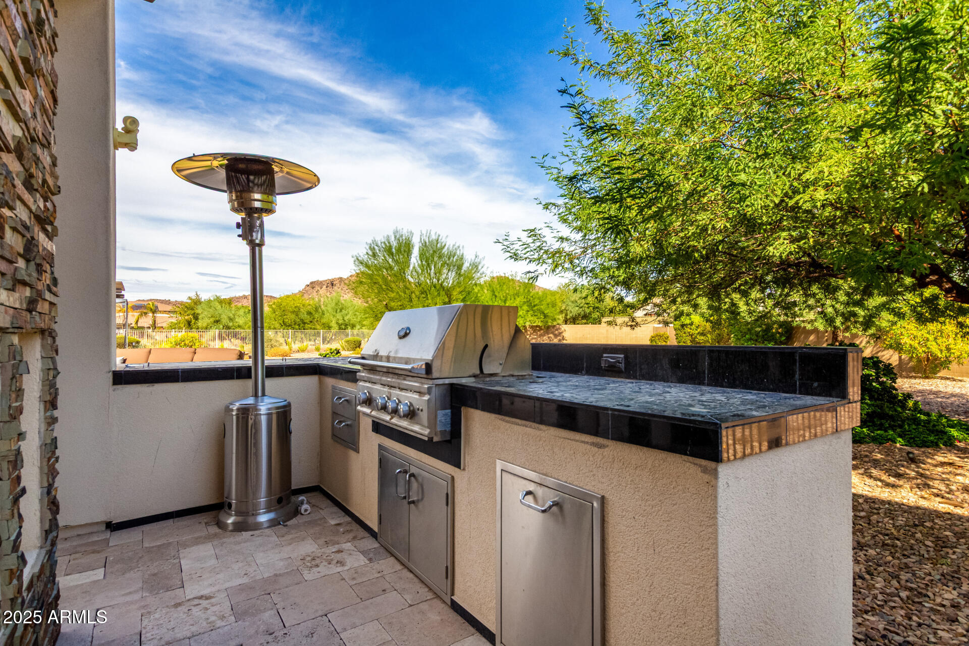 9156 West Bajada Road Peoria, AZ 85383 - Photo 69 of 97 a kitchen with stainless steel appliances kitchen island a stove and a refrigerator
