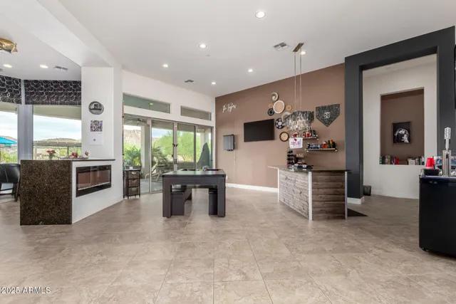 a living room with furniture a large window and a fireplace