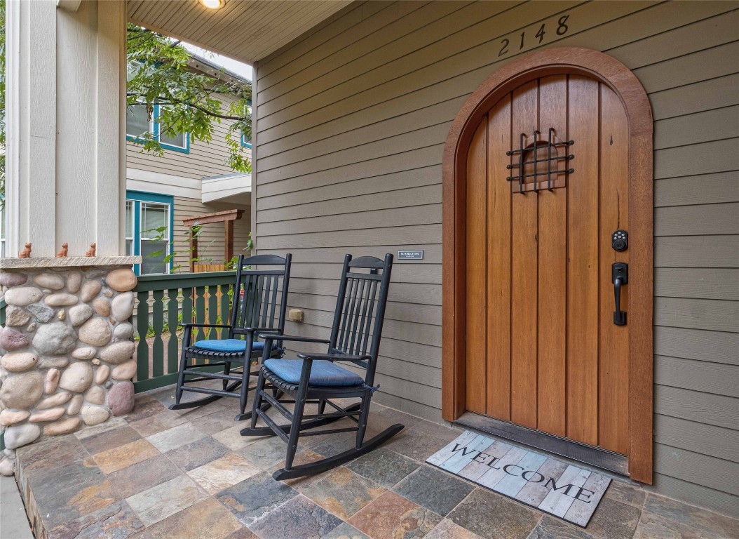 a view of a door with chair and bench