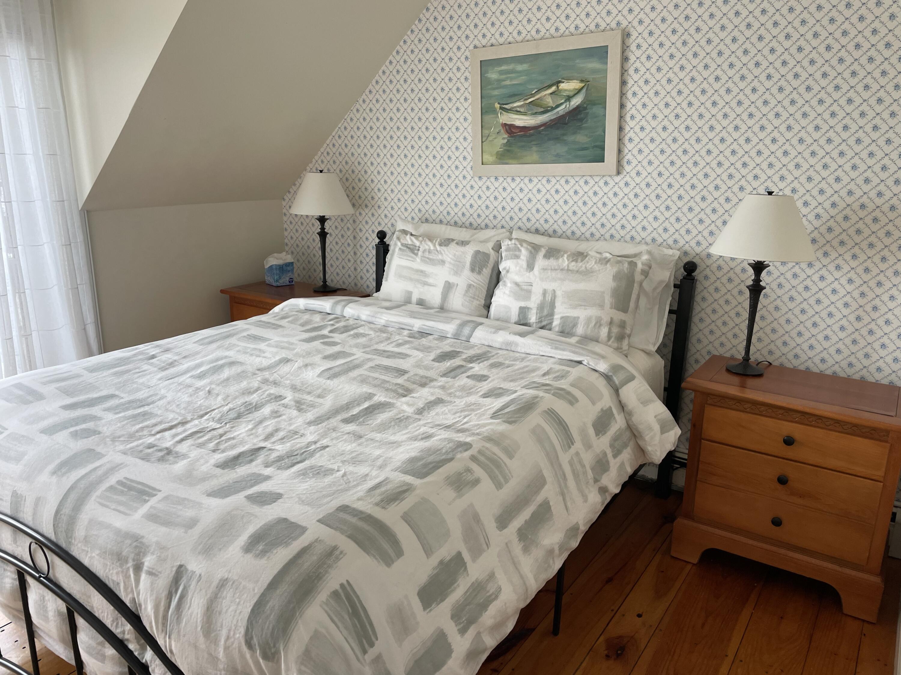 16 Brant Rock Road Mashpee, MA 02649 - Photo 13 of 23 a bedroom with a bed and a lamp on dresser