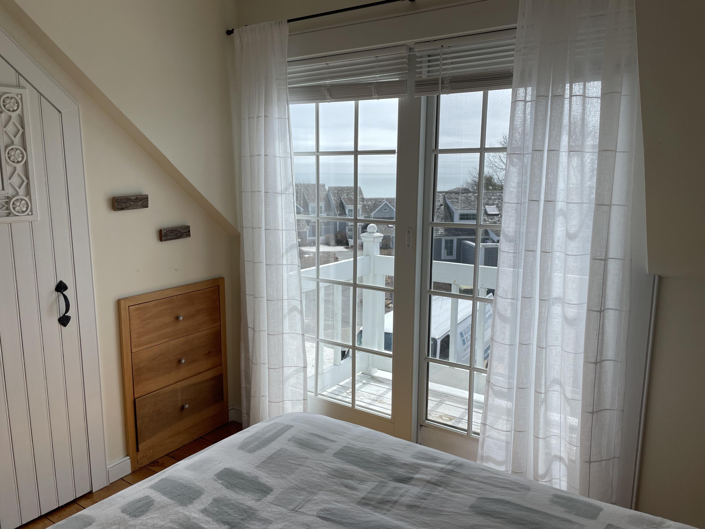 16 Brant Rock Road Mashpee, MA 02649 - Photo 14 of 23 a view of a hallway with wooden floor and door