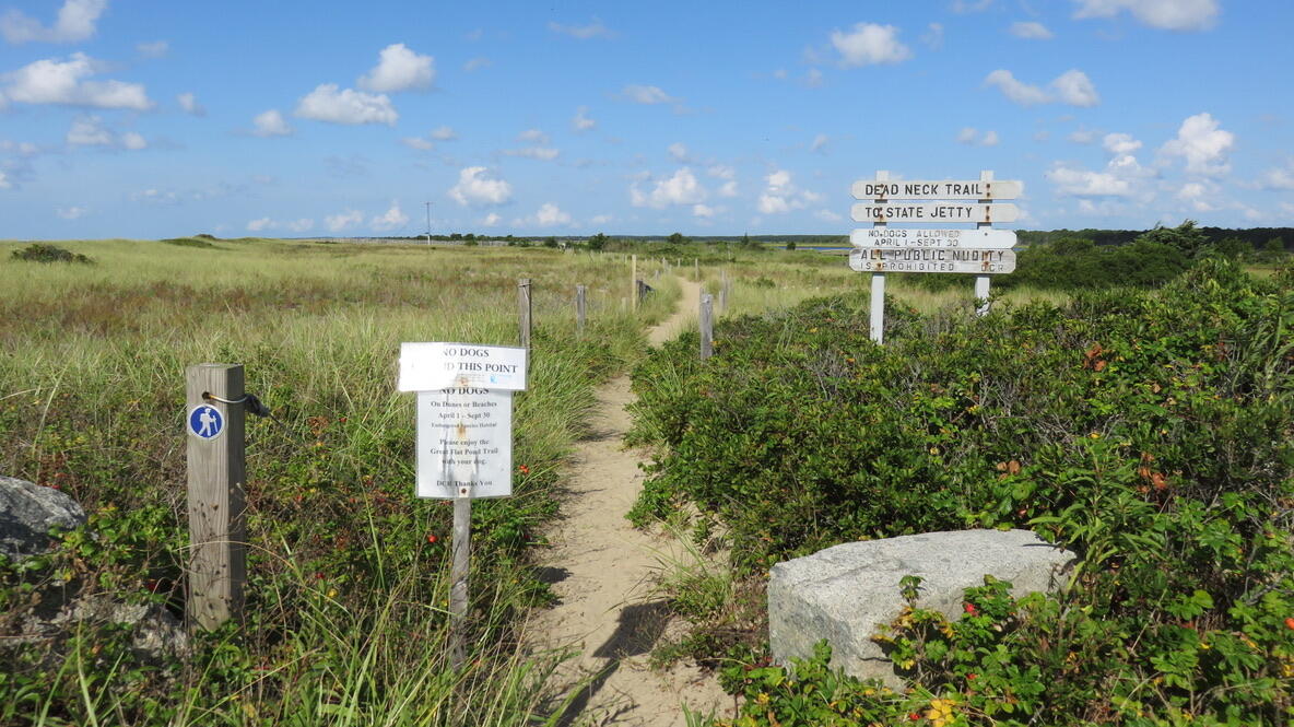 16 Brant Rock Road Mashpee, MA 02649 - Photo 20 of 23 a sign that is sitting in the grass next to a yard