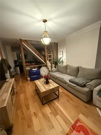 a living room with furniture a couch and chandelier