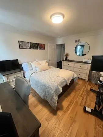 a bedroom with a bed and a dresser