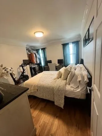 a bedroom with a bed and window