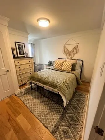 a bedroom with a bed and cupboard