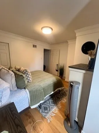 a bed sitting in a bedroom next to a window