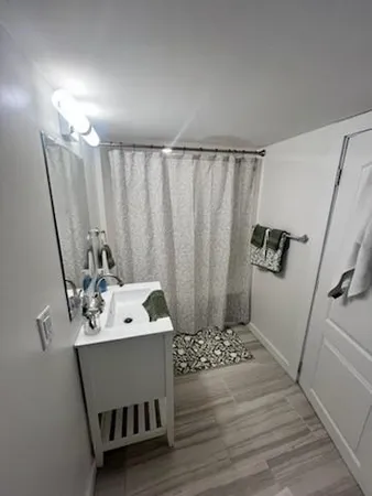 a bathroom with a sink a mirror and shower