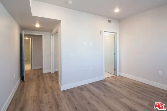 a view of hallway with wooden floor