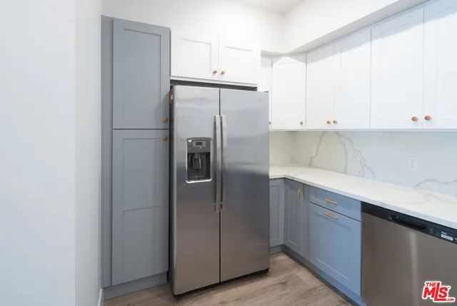 a kitchen with cabinets and stainless steel appliances