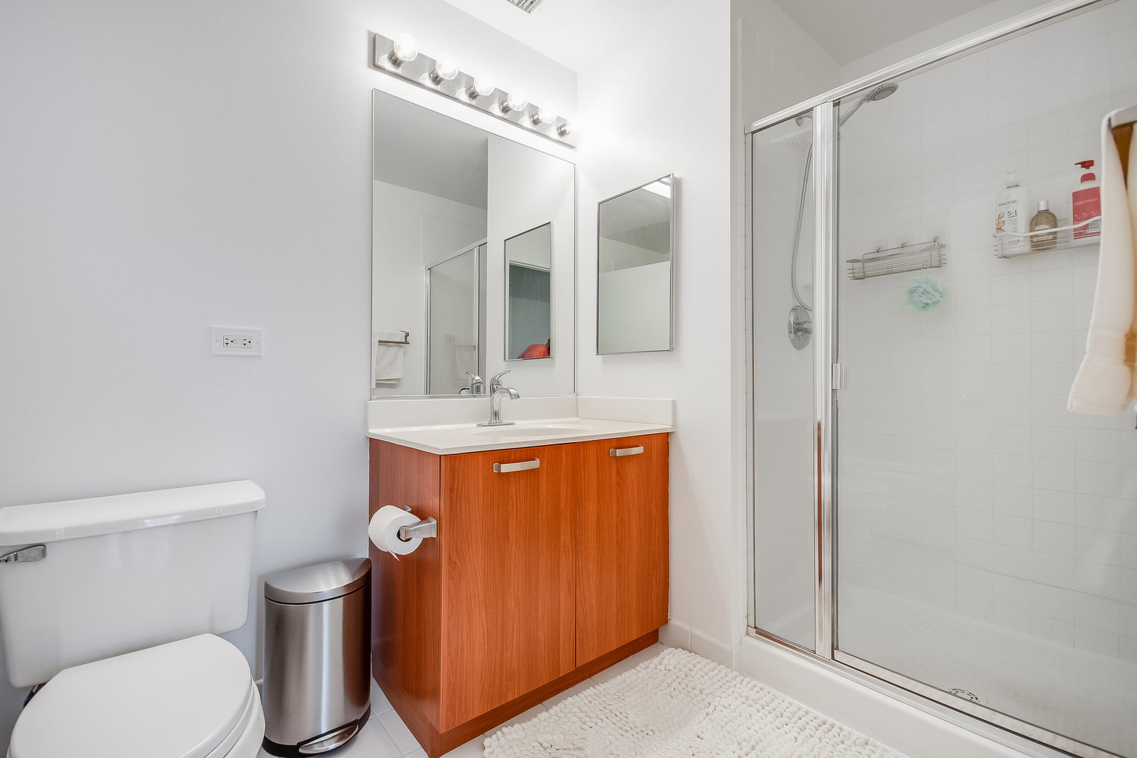 111 South Morgan Street, Unit 416 Chicago, IL 60607 - Photo 12 of 15 a bathroom with a toilet sink shower and mirror