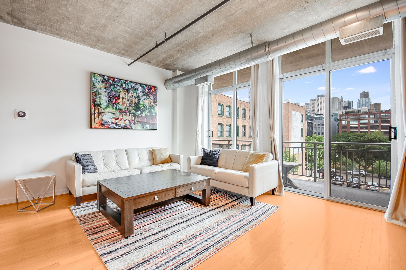 111 South Morgan Street, Unit 416 Chicago, IL 60607 - Photo 8 of 15 a living room with furniture a large window and wooden floor