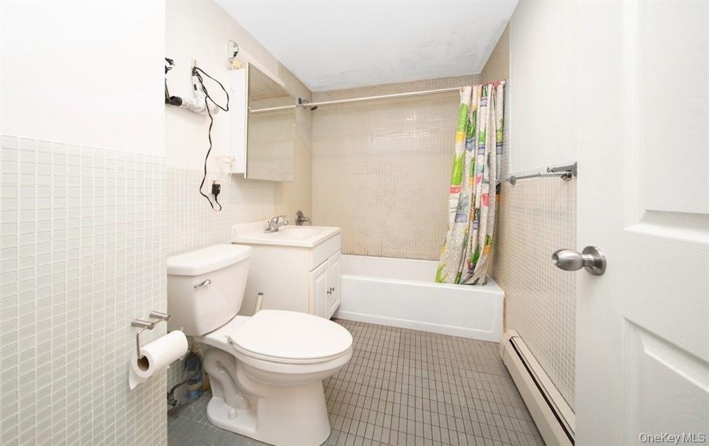 136-16 35th Avenue, Unit 7C Queens, NY 11354 - Photo 14 of 19 a bathroom with a toilet and a shower