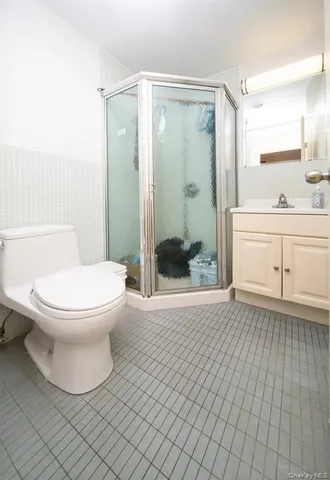 a bathroom with a granite countertop bathtub shower sink and toilet