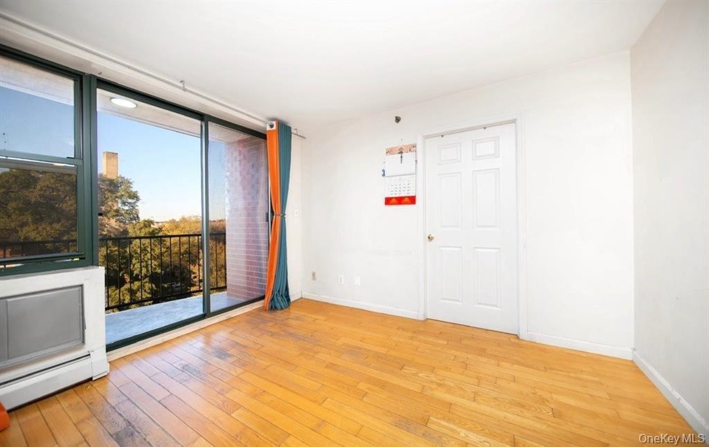 136-16 35th Avenue, Unit 7C Queens, NY 11354 - Photo 8 of 19 a view of empty room with wooden floor
