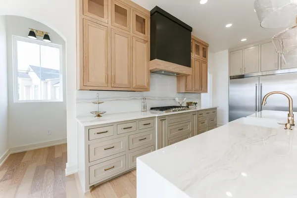 a bathroom with a double vanity sink a toilet and shower