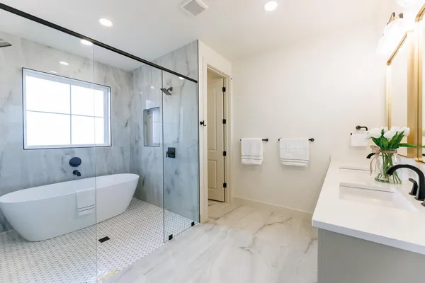 a bathroom with a granite countertop sink a toilet and a mirror