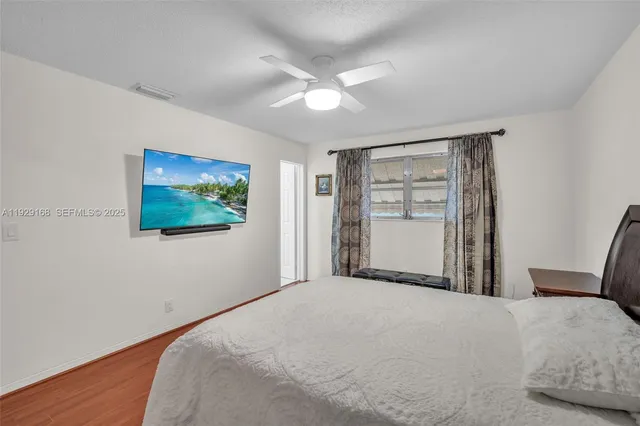 a bedroom with a large bed and a chandelier