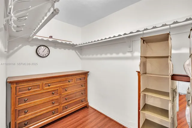 a view of walk in closet with empty racks