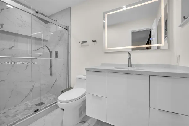a bathroom with a toilet sink and shower