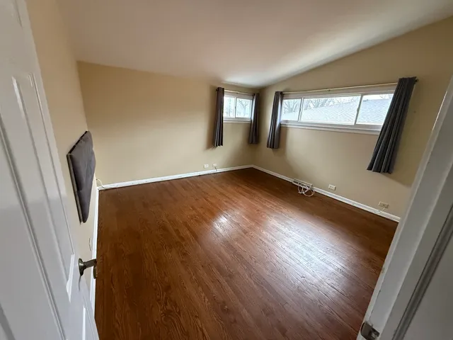 a view of wooden floor and windows in a room