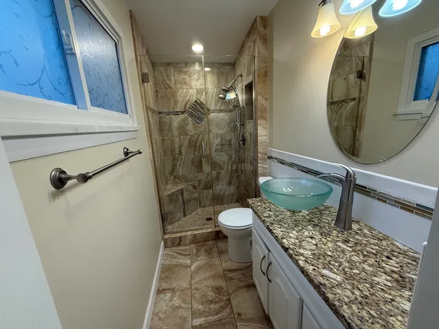 a bathroom with a sink toilet and shower