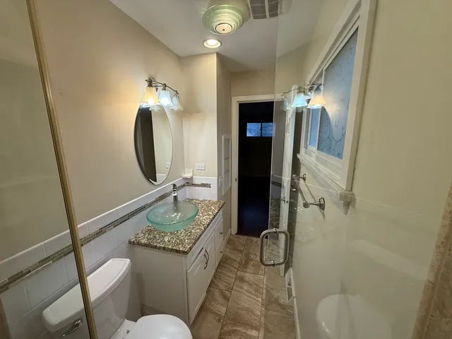 a bathroom with a shower and toilet