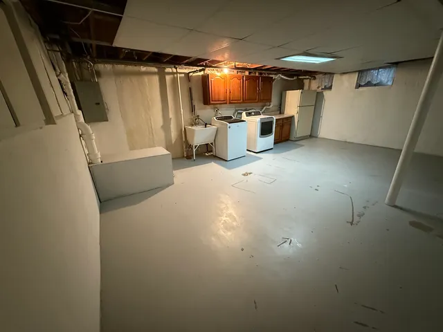 a view of a house with a yard covered in snow