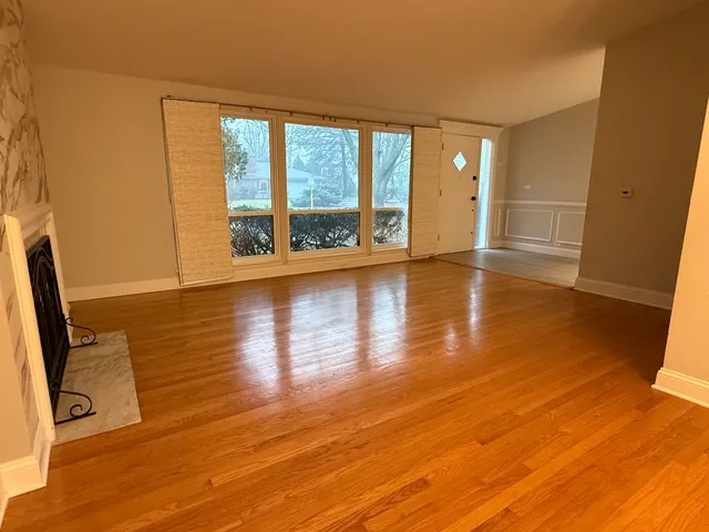 a view of a room with wooden floor and a window