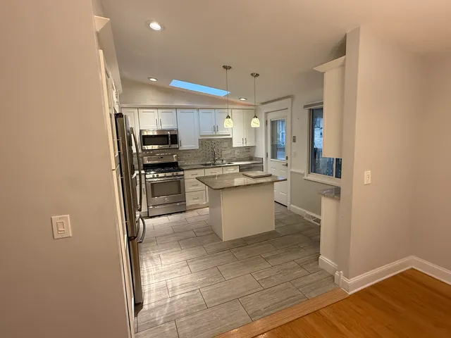 a kitchen with stainless steel appliances a refrigerator and a sink