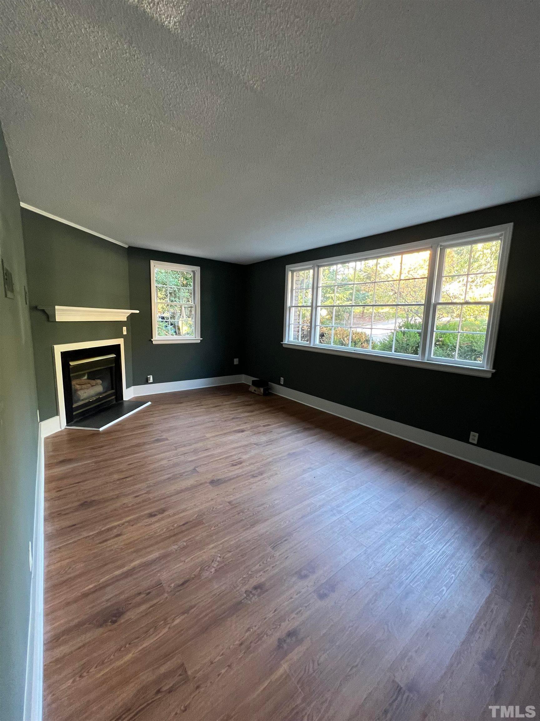 913 Brookwood Drive Raleigh, NC 27607 - Photo 11 of 23 a view of an empty room with window and fire place