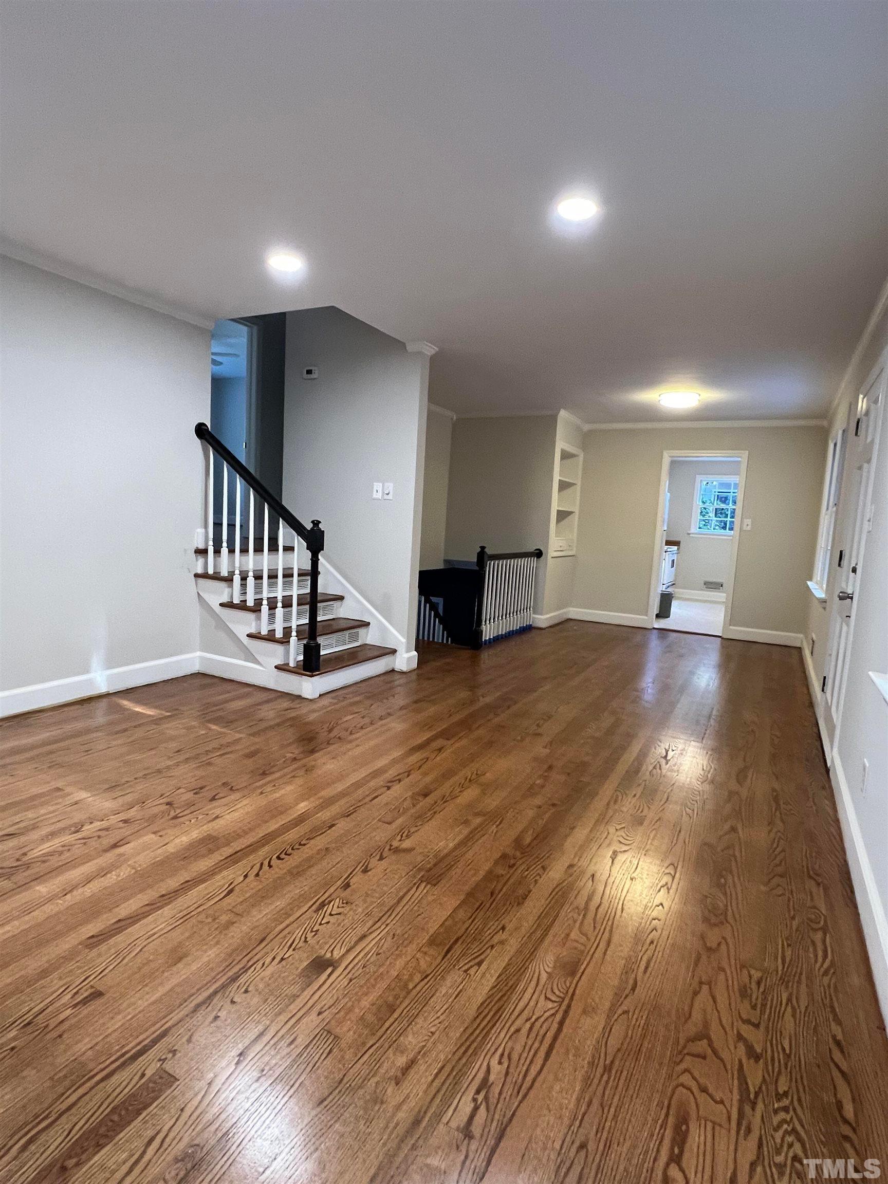 913 Brookwood Drive Raleigh, NC 27607 - Photo 23 of 23 a view of an empty room with stairs and a window