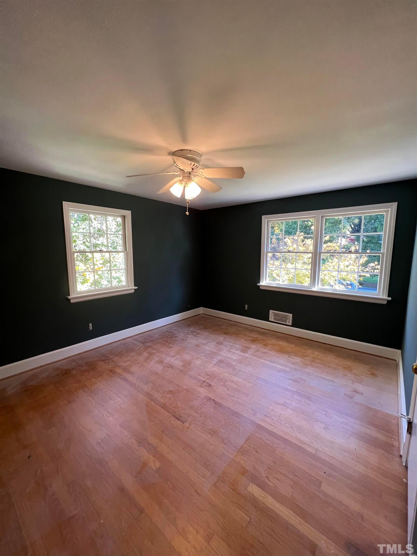 913 Brookwood Drive Raleigh, NC 27607 - Photo 7 of 23 a view of an empty room with windows and a fireplace