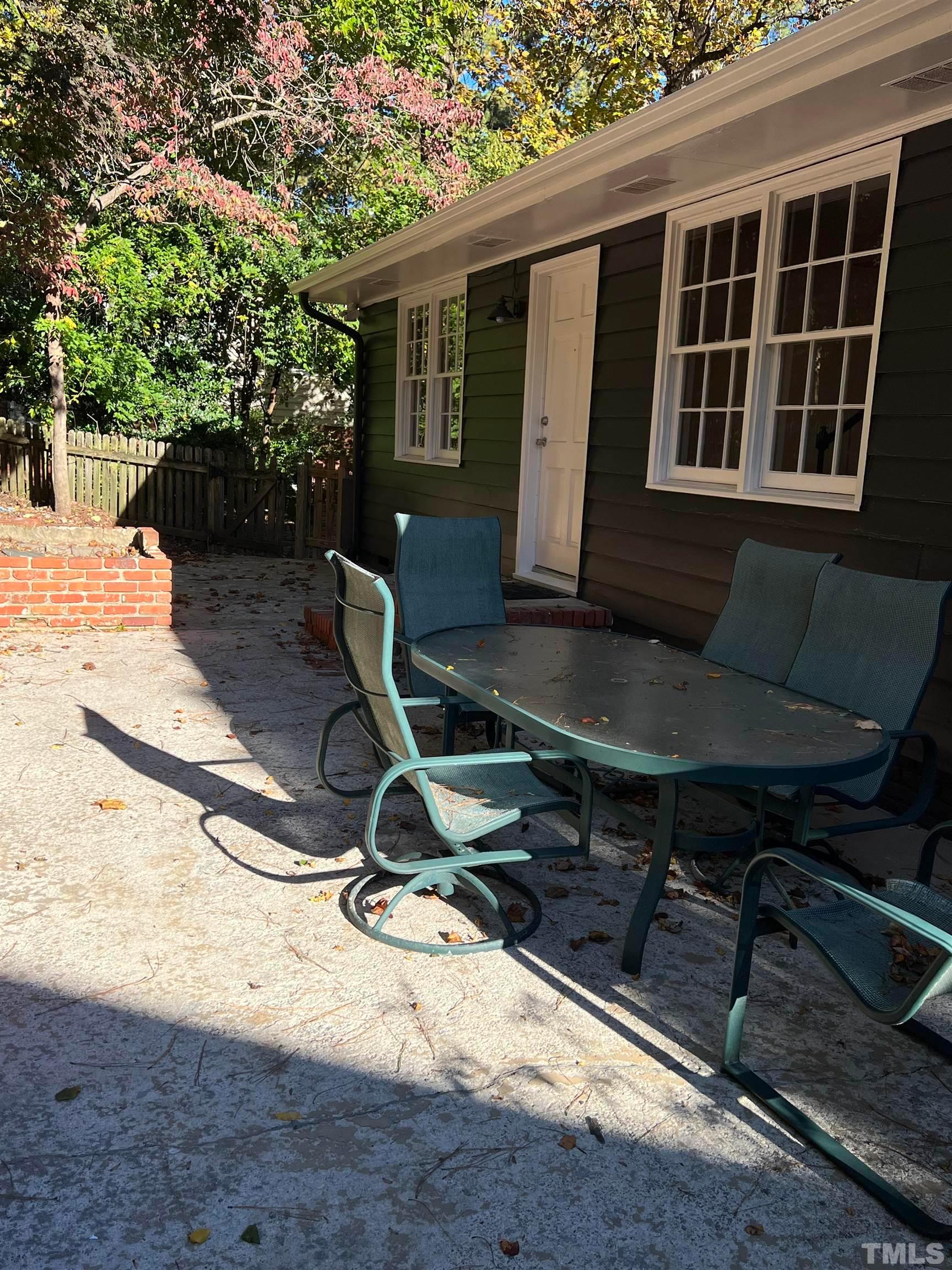 913 Brookwood Drive Raleigh, NC 27607 - Photo 9 of 23 a view of backyard with a chair and potted plant