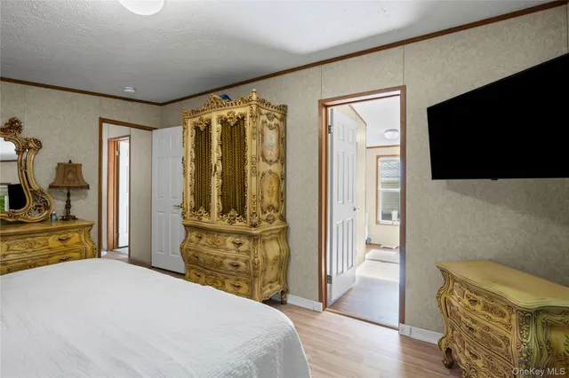 a bedroom with a bed and a mirror