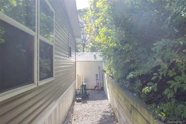 a view of a patio with table and chairs potted plants with wooden floor and fence