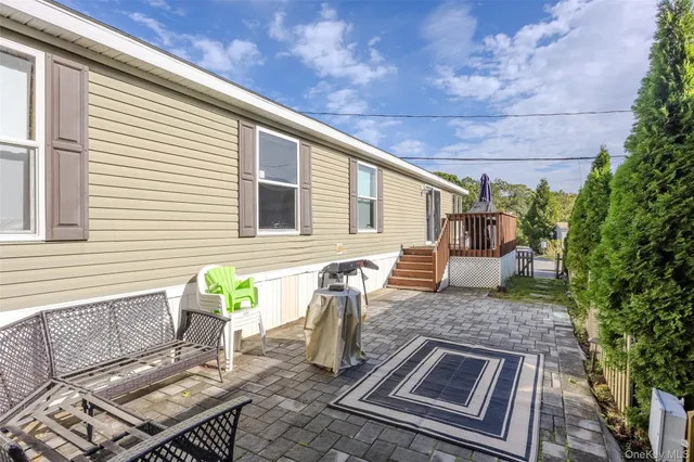 a view of a small house with backyard