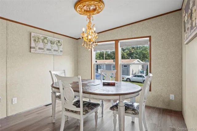 a living room with furniture a dining table and a chandelier