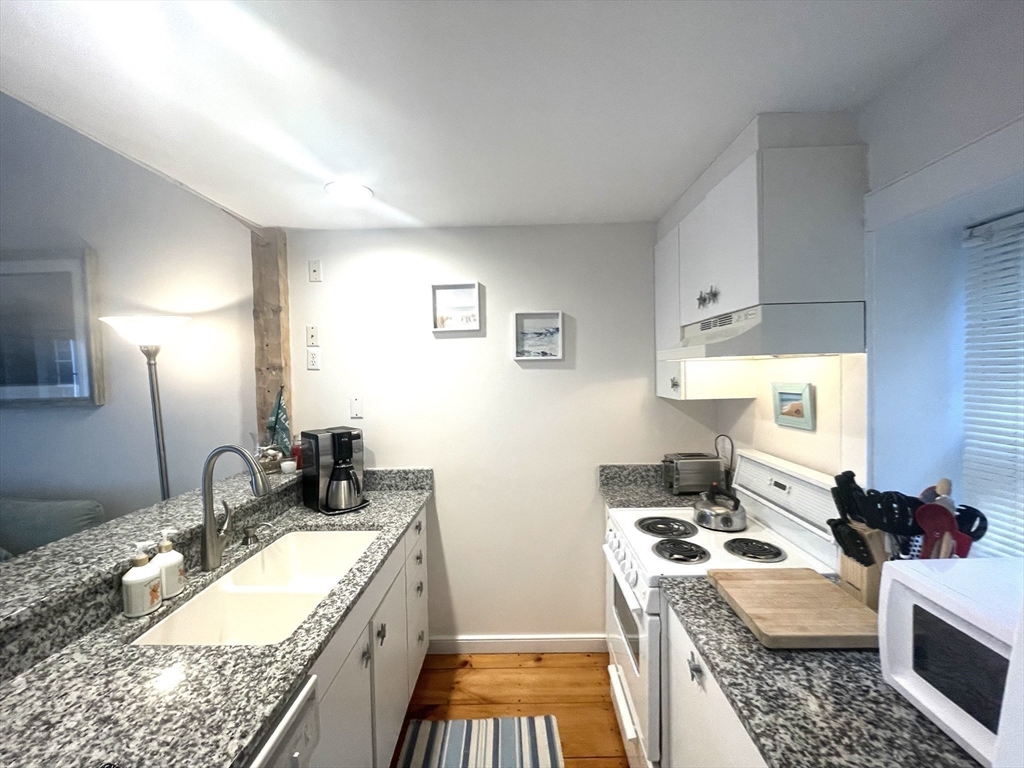 6 Hammock Pond Road, Unit 6 Mashpee, MA 02649 - Photo 14 of 31 a kitchen with a granite countertop sink and a stove