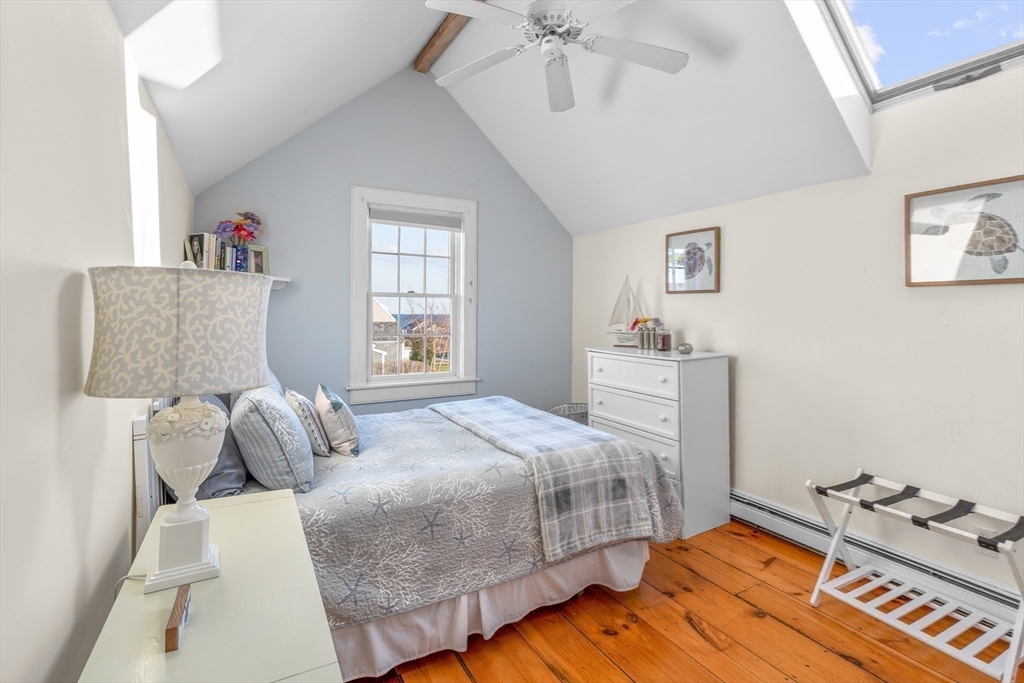 6 Hammock Pond Road, Unit 6 Mashpee, MA 02649 - Photo 24 of 31 a bedroom with a bed and wooden floor