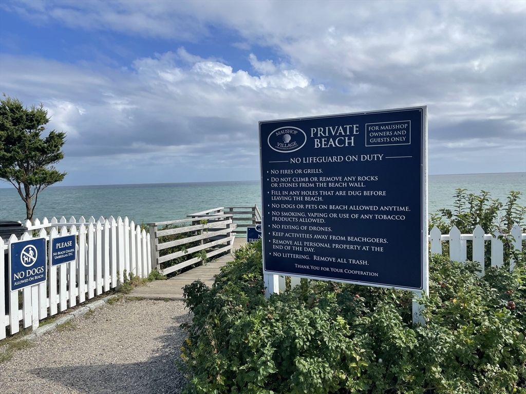 6 Hammock Pond Road, Unit 6 Mashpee, MA 02649 - Photo 27 of 31 a sign on the side of a building