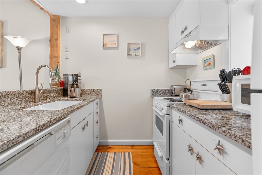 6 Hammock Pond Road, Unit 6 Mashpee, MA 02649 - Photo 8 of 31 a kitchen with a sink stove and cabinets