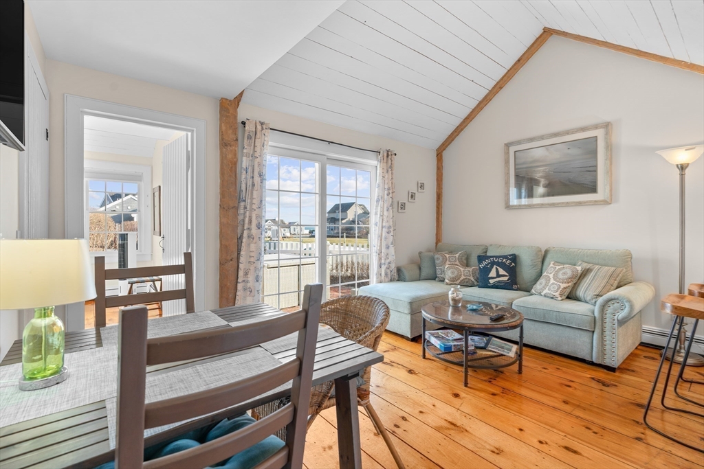 6 Hammock Pond Road, Unit 6 Mashpee, MA 02649 - Photo 10 of 31 a living room with furniture and a table