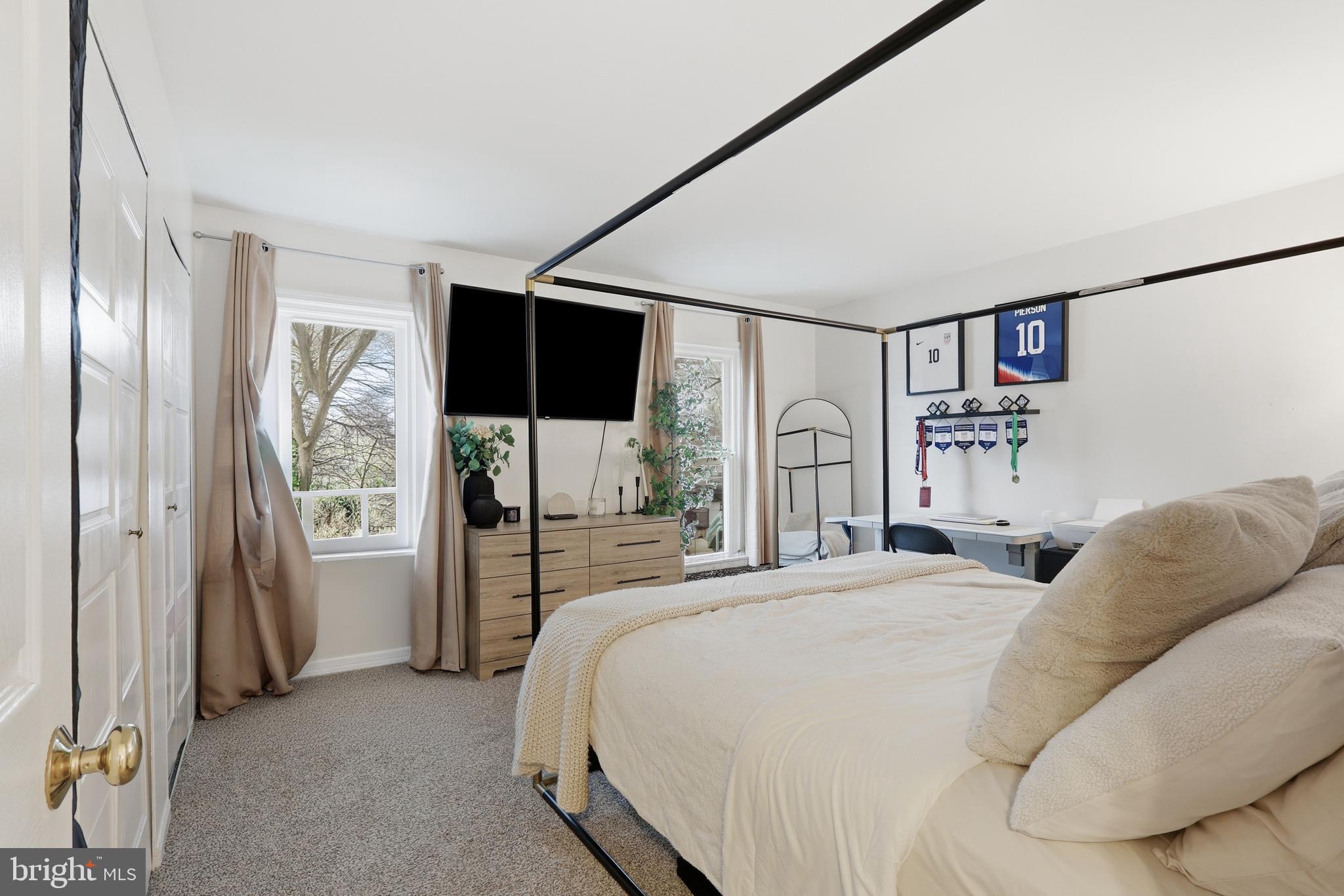 112 North Kennedy Road Sterling, VA 20164 - Photo 14 of 39 a bedroom with a large bed and a flat tv screen